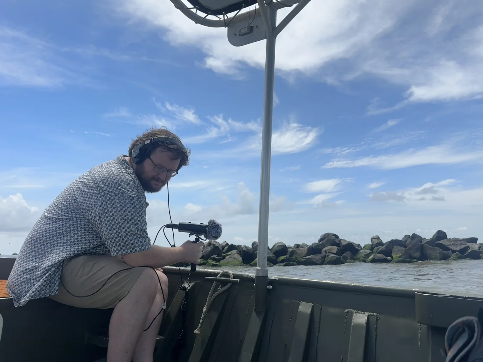 Field recording work on a boat in the Mississippi River Delta